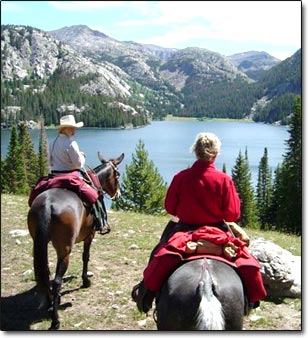 Christine on the left on her mule Pass the Buck and mom on the right on her mule, Sweetheart.